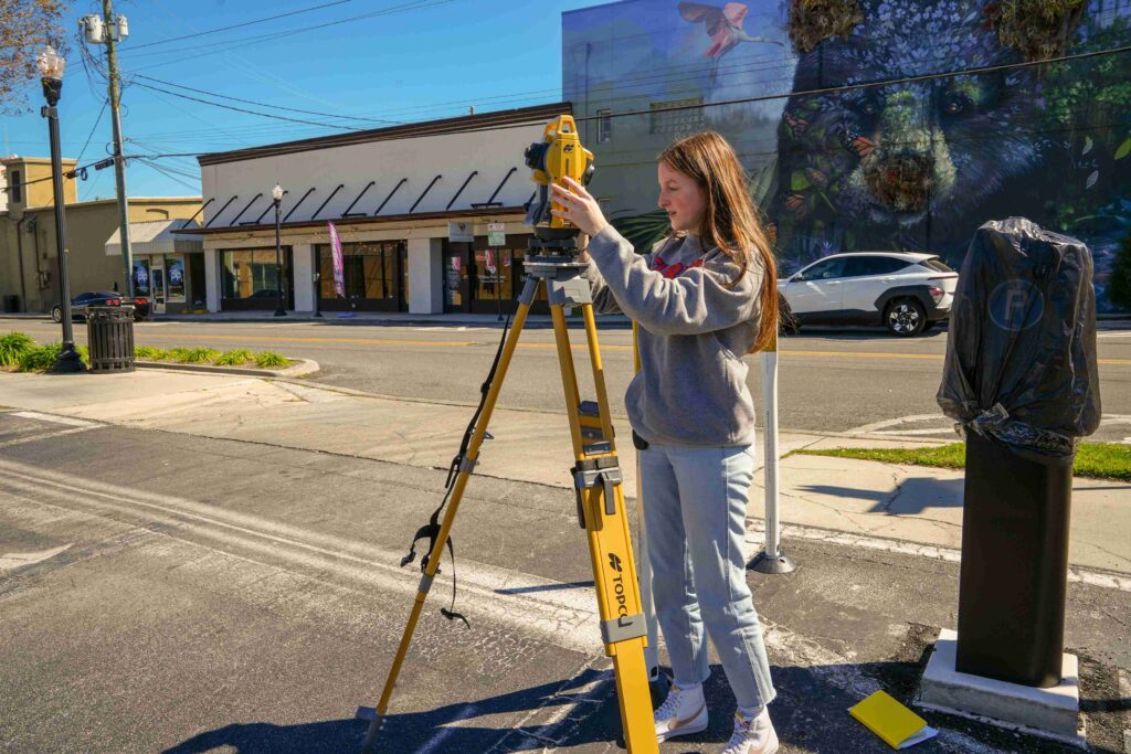 Geomatics student in Ocala Florida asks questions about surveying instrument. 