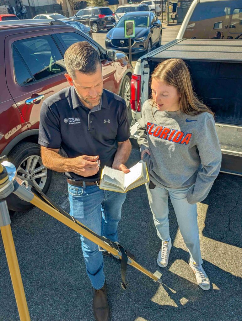 CFB Surveying mentor discusses notes with his UF geomatics student mentee during a lab assignment. 