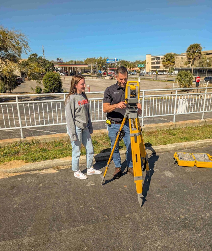CFB Land Surveyor reviews work of his student mentee during a practice assignment in downtown Ocala Florida. 