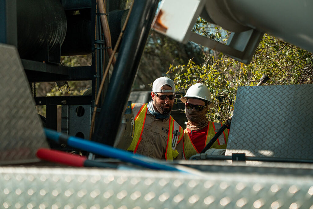 CFB Surveying SUE crew reviewing vacuum truck equipment on site